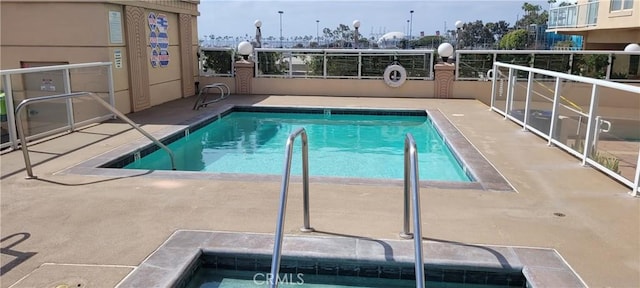 view of swimming pool featuring a patio area