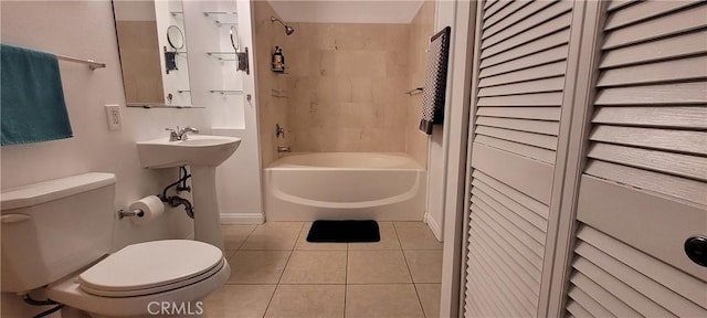 bathroom with toilet, tiled shower / bath combo, and tile patterned flooring