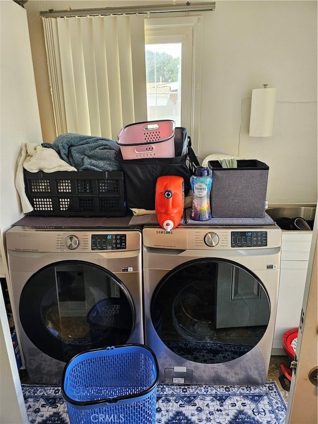 laundry area with independent washer and dryer