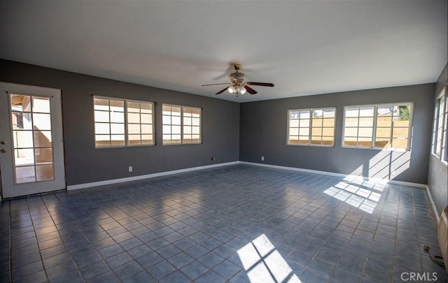 tiled spare room with ceiling fan