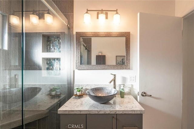 bathroom with vanity and a shower with shower door