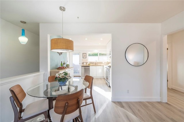 dining area featuring sink and light hardwood / wood-style floors