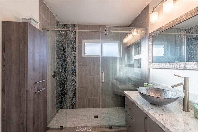 bathroom with walk in shower and vanity