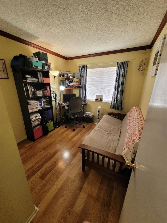 office with hardwood / wood-style flooring, ornamental molding, and a textured ceiling