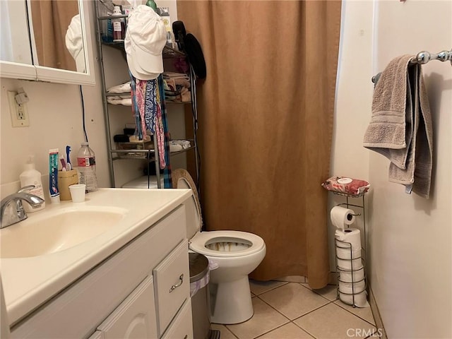 bathroom featuring vanity, toilet, and tile patterned flooring