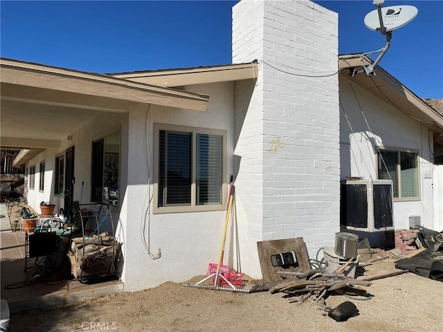 view of side of home with a patio area