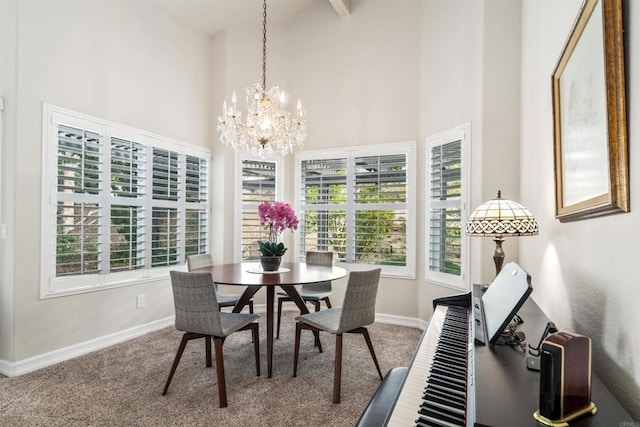 dining area with carpet floors, a chandelier, and a high ceiling