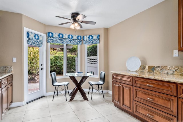 dining area featuring light tile patterned floors and ceiling fan