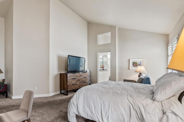 bedroom with lofted ceiling, ensuite bathroom, and carpet