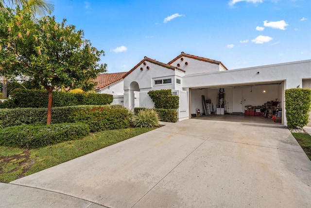 mediterranean / spanish home featuring a garage