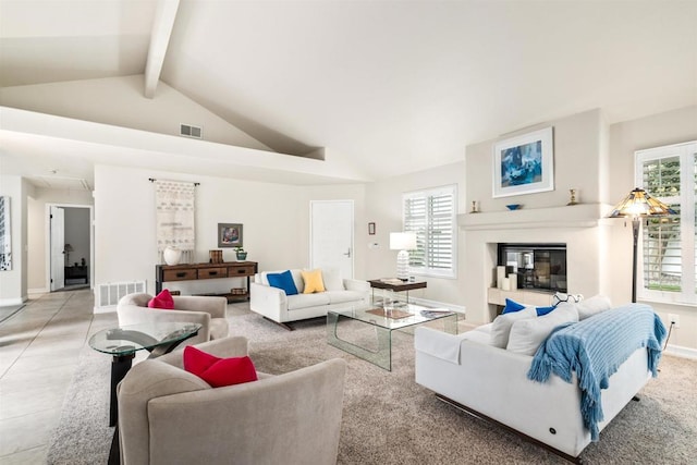 living room with beam ceiling and high vaulted ceiling