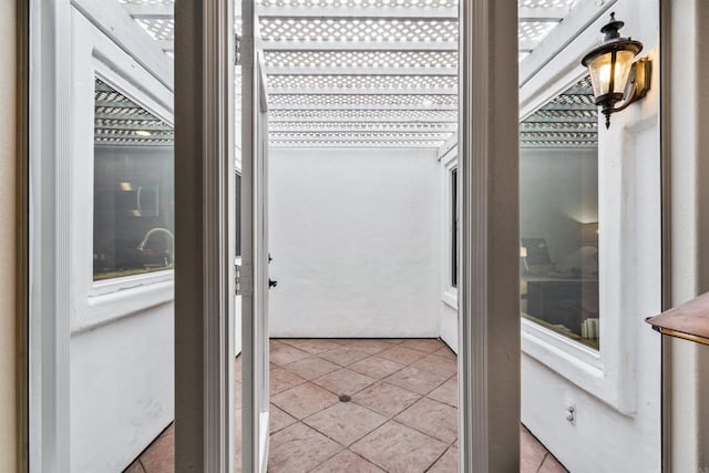 doorway with light tile patterned floors