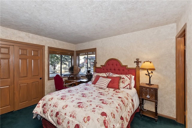 bedroom featuring a textured ceiling and dark carpet