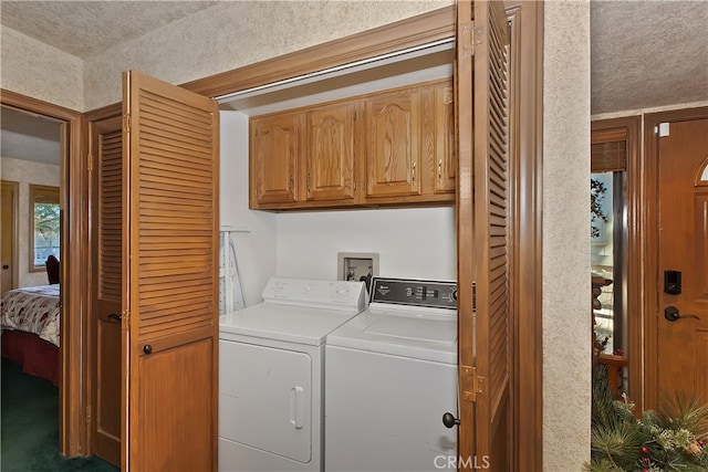 washroom featuring cabinets and washing machine and clothes dryer