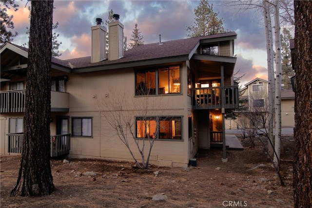 view of back house at dusk