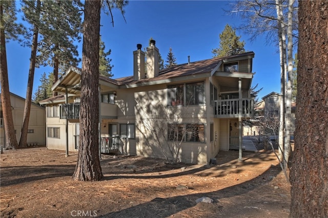 rear view of property featuring a balcony