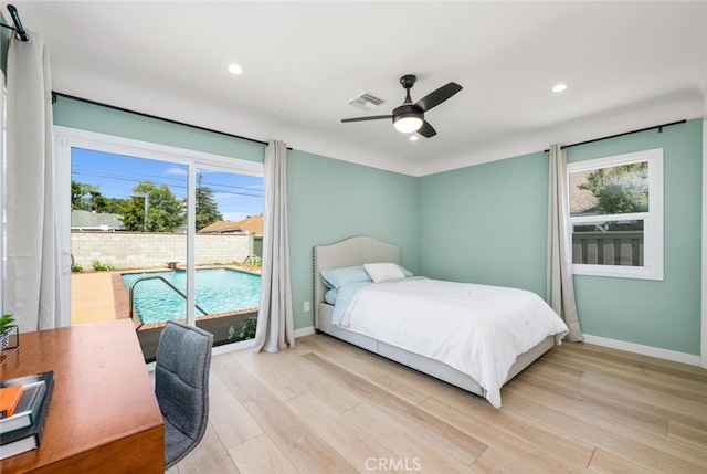 bedroom featuring ceiling fan, access to exterior, multiple windows, and light hardwood / wood-style flooring