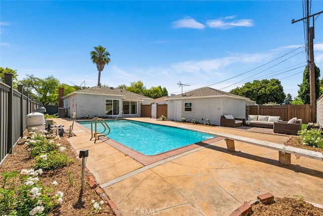 view of swimming pool with an outdoor living space, a patio area, and a diving board