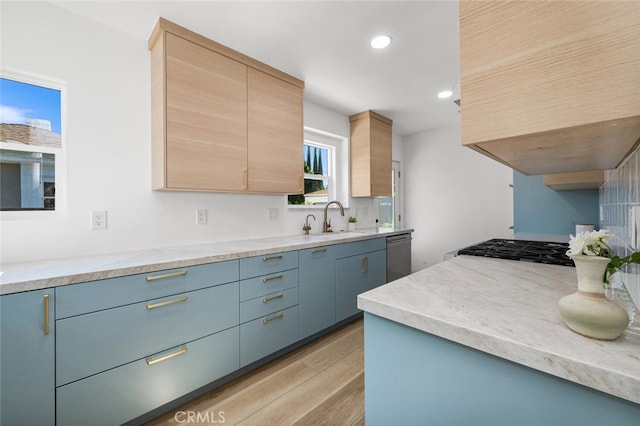 kitchen with sink, dishwasher, extractor fan, light brown cabinetry, and light wood-type flooring