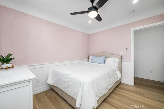 bedroom with ceiling fan and light hardwood / wood-style flooring