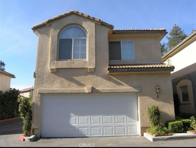 mediterranean / spanish-style home featuring a garage