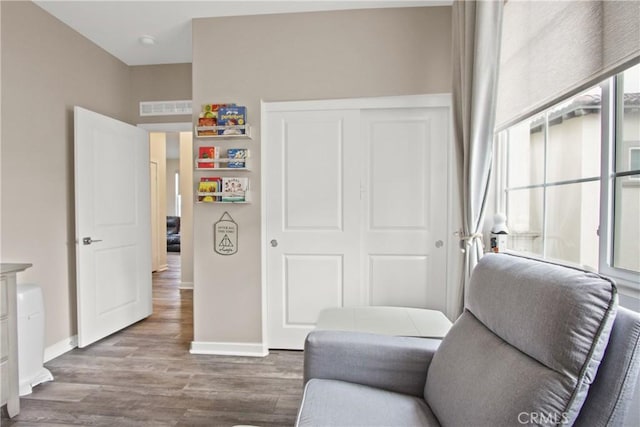 sitting room with wood-type flooring