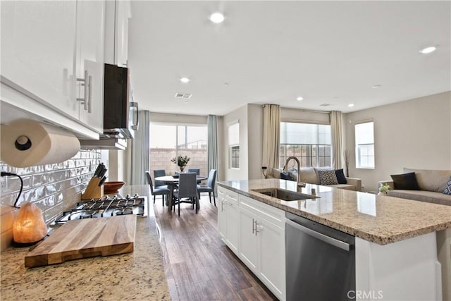 kitchen featuring sink, white cabinetry, a kitchen island with sink, light stone counters, and stainless steel dishwasher