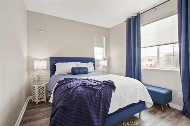 bedroom featuring dark wood-type flooring and multiple windows