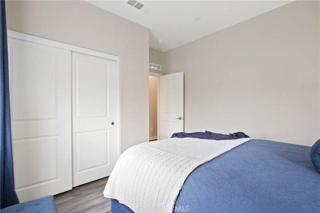 bedroom featuring hardwood / wood-style flooring and a closet