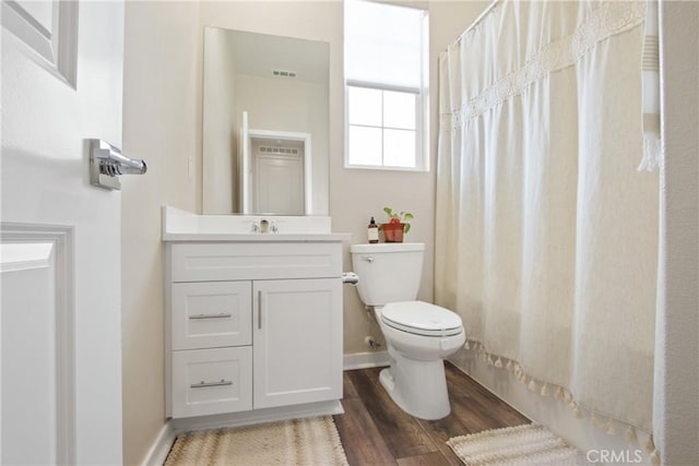 bathroom with vanity, wood-type flooring, curtained shower, and toilet