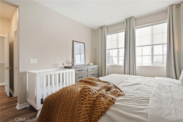 bedroom with dark wood-type flooring