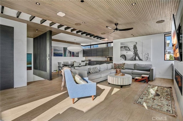 living room with ceiling fan, light hardwood / wood-style flooring, and wooden ceiling