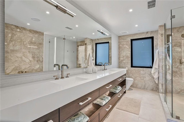 bathroom featuring walk in shower, tile patterned floors, toilet, tile walls, and vanity