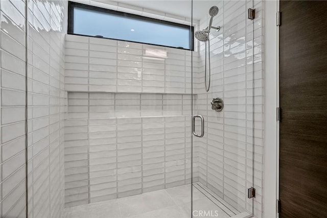 bathroom with a shower with door