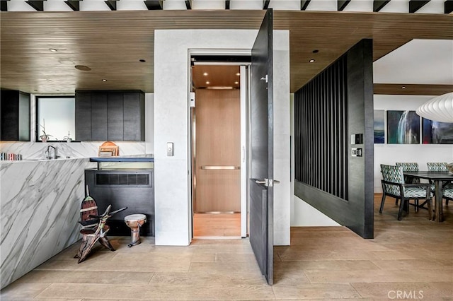 bathroom with sink, hardwood / wood-style floors, and wooden ceiling