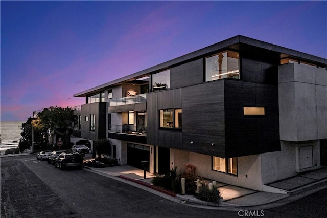 outdoor building at dusk featuring a water view