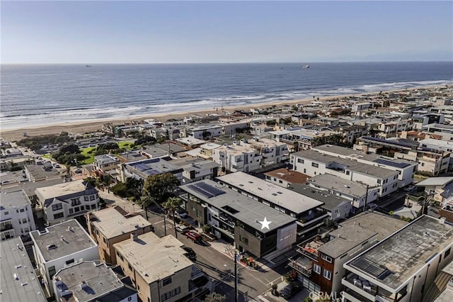 aerial view with a water view and a beach view