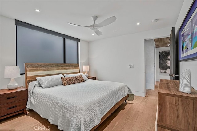 bedroom with light hardwood / wood-style floors and ceiling fan