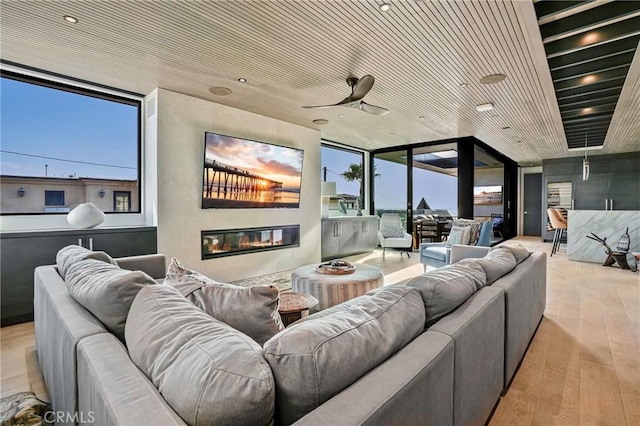405 26th St, Manhattan Beach, CA 90266 - cinema room with a glass covered fireplace, wood-type flooring, and plenty of natural light