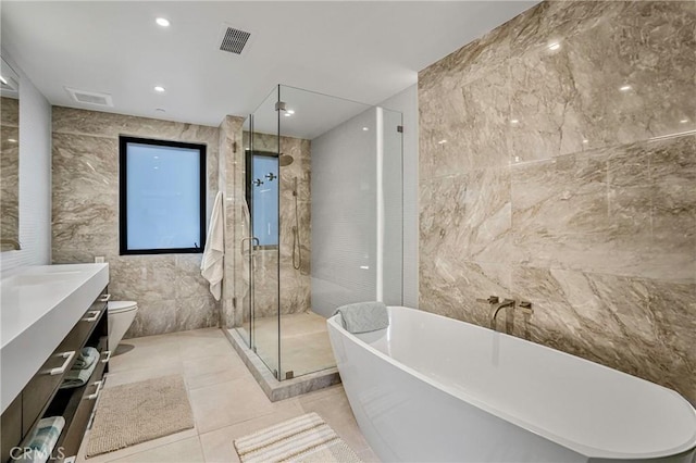 405 26th St, Manhattan Beach, CA 90266 - full bathroom featuring tile walls, a freestanding tub, a stall shower, toilet, and vanity