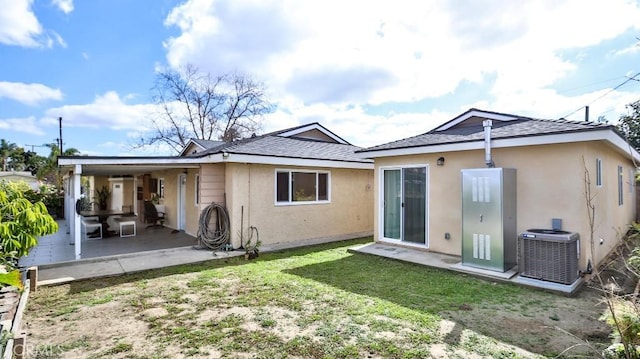 back of house with a yard, central AC unit, and a patio