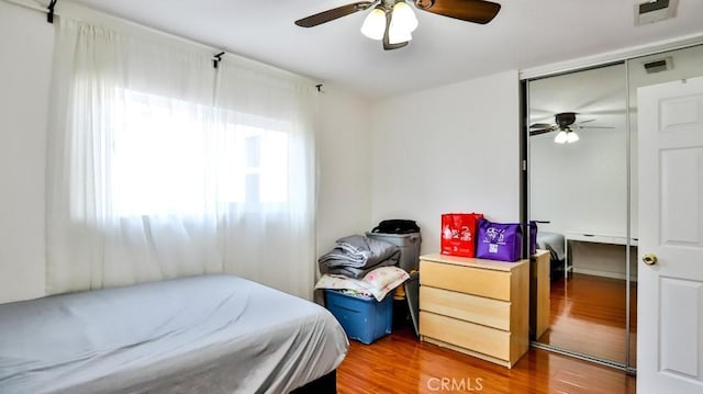 bedroom featuring hardwood / wood-style floors, ceiling fan, and a closet