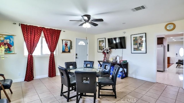 dining area with ceiling fan and light tile patterned flooring