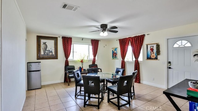 dining space with ceiling fan and light tile patterned floors