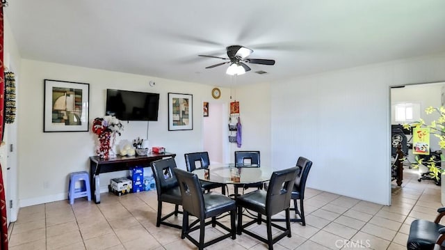 tiled dining room featuring ceiling fan