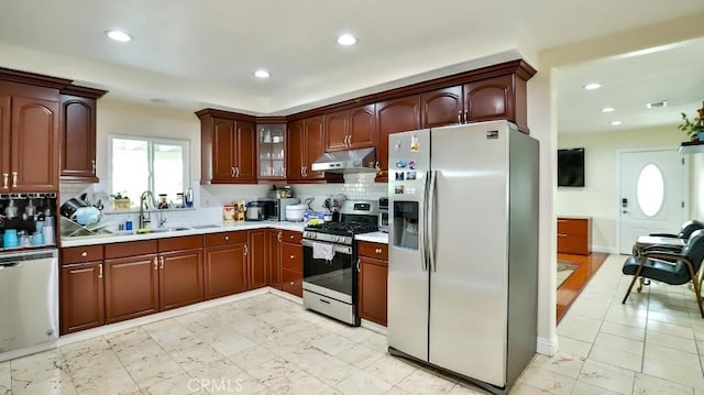 kitchen featuring tasteful backsplash, sink, and stainless steel appliances