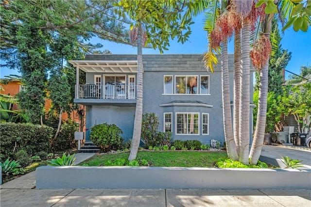 view of front of home featuring a balcony and stucco siding