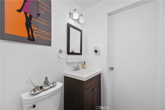 bathroom featuring toilet and vanity