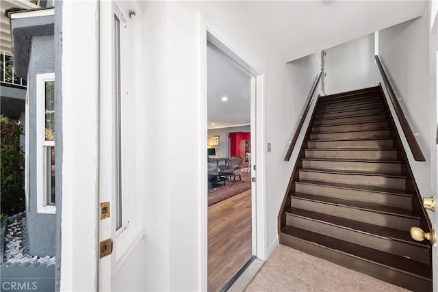 staircase featuring tile patterned flooring and baseboards