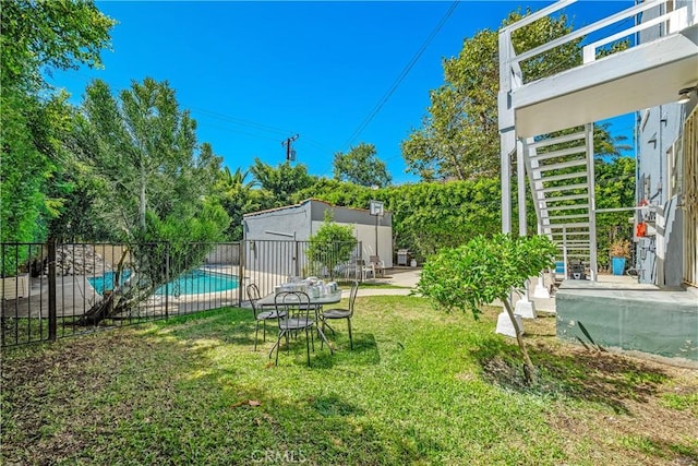 view of yard featuring a patio area, fence, and a fenced in pool